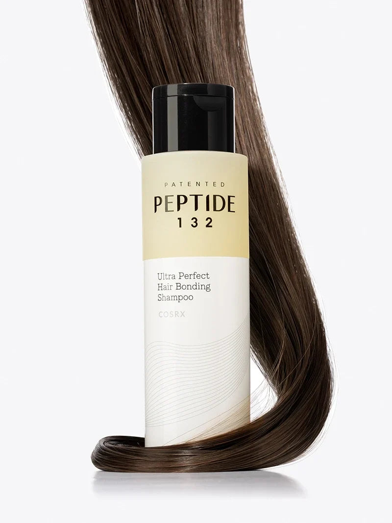 COSRX PEPTIDE-132 Ultra Perfect Hair Bonding Shampoo 400ml bottle with a lock of hair, fully visible against a light background.